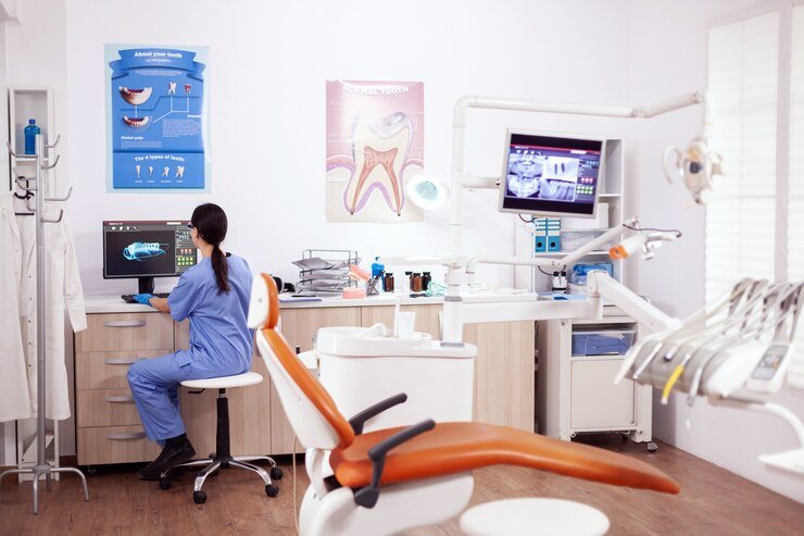 stomatology-office-with-modern-equipment-nurse-wearing-blue-uniform-working-computer_482257-12534